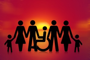 A sunshet shows a family in silhouette. One person sits in a wheelchair
